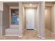 Welcoming foyer with neutral paint, tiled floor, and a built-in bench by the window at 10846 E Quartet Ave, Mesa, AZ 85212