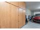 A spacious garage features ample storage cabinets and room for parking a car at 10846 E Quartet Ave, Mesa, AZ 85212