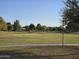 Expansive green space with mature trees offers a peaceful park setting at 10846 E Quartet Ave, Mesa, AZ 85212
