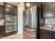 Kitchen featuring stainless steel appliances and dark wood cabinets at 10846 E Quartet Ave, Mesa, AZ 85212