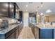 Stylish kitchen with sleek dark cabinetry, granite counters, and stainless steel appliances at 10846 E Quartet Ave, Mesa, AZ 85212