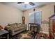 Cozy living room with a comfortable sofa, area rug, table with stools, and natural light at 10846 E Quartet Ave, Mesa, AZ 85212