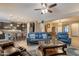 Open-concept living room with comfortable seating, a ceiling fan, and a view of the adjacent kitchen at 10846 E Quartet Ave, Mesa, AZ 85212