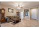 Spacious living room with a cozy sofa, decorative accents, and bright natural light at 10846 E Quartet Ave, Mesa, AZ 85212