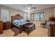 Bedroom with ceiling fan, natural light, dark wood furniture and carpet floors at 10846 E Quartet Ave, Mesa, AZ 85212