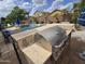 Outdoor kitchen with stainless steel grill, bar seating, and view of the backyard pool at 10846 E Quartet Ave, Mesa, AZ 85212