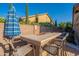 Outdoor kitchen features stone surround, stainless steel grill, counter seating, and pergola at 10846 E Quartet Ave, Mesa, AZ 85212