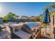 Outdoor kitchen features stone surround, stainless steel grill, counter seating, and covered patio at 10846 E Quartet Ave, Mesa, AZ 85212