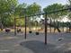 Playground with swings, slides and climbing structures, with a pond in the background at 10846 E Quartet Ave, Mesa, AZ 85212