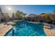 Backyard pool with a spa, water features, lounge chairs, and mature landscaping at 10846 E Quartet Ave, Mesa, AZ 85212