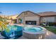 Inviting backyard pool and spa with lush landscaping and covered patio at 10846 E Quartet Ave, Mesa, AZ 85212