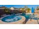 Inviting backyard pool and spa with lush landscaping and tanning ledge for ultimate relaxation at 10846 E Quartet Ave, Mesa, AZ 85212