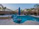 Inviting backyard pool and spa with lush landscaping and tanning ledge for ultimate relaxation at 10846 E Quartet Ave, Mesa, AZ 85212