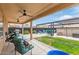 Outdoor patio featuring ample seating, lush greenery, a grill, and a hot tub at 1231 W Beacon Ct, Casa Grande, AZ 85122