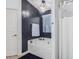 Bathroom featuring a soaking tub, dark accent wall, and an elegant chandelier at 1231 W Beacon Ct, Casa Grande, AZ 85122