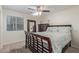 Inviting bedroom with a large bed, dresser, and a ceiling fan with a light at 1231 W Beacon Ct, Casa Grande, AZ 85122