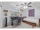 Bedroom featuring a desk, bed, ceiling fan, and a window for natural light at 1231 W Beacon Ct, Casa Grande, AZ 85122