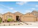Charming single-story home featuring a desert landscaped front yard and attached two-car garage at 1231 W Beacon Ct, Casa Grande, AZ 85122