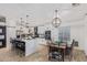 Bright open floor plan kitchen and dining area features white cabinets and stainless steel appliances at 1231 W Beacon Ct, Casa Grande, AZ 85122