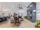 Open-concept living room with a ceiling fan, modern light fixtures, kitchen island, and dining area at 1231 W Beacon Ct, Casa Grande, AZ 85122