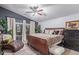 Cozy main bedroom featuring a ceiling fan, large windows, and stylish decor at 1231 W Beacon Ct, Casa Grande, AZ 85122