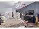 Comfortable main bedroom featuring a dark accent wall, plush furnishings, and ample natural light at 1231 W Beacon Ct, Casa Grande, AZ 85122