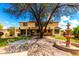 Spacious backyard with a large patio, fountain, mature landscaping, and outdoor dining area, perfect for entertaining at 13932 N 135Th Dr, Surprise, AZ 85379