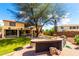 Large backyard featuring an outdoor kitchen, mature tree, and a brick-paved patio great for outdoor relaxation at 13932 N 135Th Dr, Surprise, AZ 85379