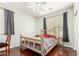 Bedroom features a log-style bed, hardwood floors, and neutral walls at 13932 N 135Th Dr, Surprise, AZ 85379