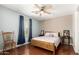 Comfortable bedroom with a ceiling fan, natural light, and stylish furnishings at 13932 N 135Th Dr, Surprise, AZ 85379