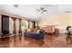 Spacious main bedroom with hardwood floors, a ceiling fan, and large windows providing natural light at 13932 N 135Th Dr, Surprise, AZ 85379