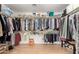 Walk-in closet providing ample storage with rods, shelves, and well-organized clothing at 13932 N 135Th Dr, Surprise, AZ 85379