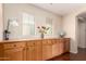 Bright dining area featuring built-in cabinets, wooden floors, and natural light from the window at 13932 N 135Th Dr, Surprise, AZ 85379
