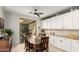 Cozy dining area with a ceiling fan, slider doors, and ample cabinet space at 13932 N 135Th Dr, Surprise, AZ 85379