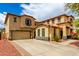Expansive two-story home featuring a wide driveway and landscaped front yard at 13932 N 135Th Dr, Surprise, AZ 85379
