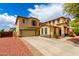 Spacious two-story home with a large driveway and well-maintained landscaping at 13932 N 135Th Dr, Surprise, AZ 85379