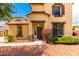 Inviting two-story home featuring a well-maintained front yard with mature landscaping at 13932 N 135Th Dr, Surprise, AZ 85379