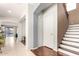 Inviting hallway featuring tile floors, neutral paint, and access to stairs at 13932 N 135Th Dr, Surprise, AZ 85379