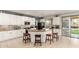 Spacious kitchen featuring white cabinets, an island with seating, and tile flooring at 13932 N 135Th Dr, Surprise, AZ 85379
