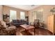 Comfortable living room featuring a plush sofa, patterned armchairs, and bright natural light at 13932 N 135Th Dr, Surprise, AZ 85379