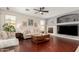 Comfortable living room with a fireplace, hardwood floors, and neutral color scheme at 13932 N 135Th Dr, Surprise, AZ 85379