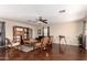 Open living room featuring hardwood floors, a ceiling fan, and a cozy seating area at 13932 N 135Th Dr, Surprise, AZ 85379