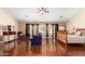 Spacious main bedroom with dark wood floors, neutral walls, and comfortable furnishings at 13932 N 135Th Dr, Surprise, AZ 85379
