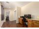 Office featuring built-in desk, storage cabinets, and wood-style flooring at 13932 N 135Th Dr, Surprise, AZ 85379