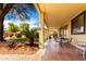 Spacious covered patio with tiled flooring, an outdoor dining area, and a view of the backyard at 13932 N 135Th Dr, Surprise, AZ 85379
