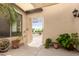 Private patio with a wrought-iron gate entry, lush greenery, and serene atmosphere at 13932 N 135Th Dr, Surprise, AZ 85379