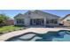 Backyard view of the home with a covered patio and a luxurious swimming pool at 1394 E Grand Canyon Dr, Chandler, AZ 85249