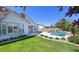 Beautiful backyard showcasing a private pool, green lawn, and lush landscaping at 1394 E Grand Canyon Dr, Chandler, AZ 85249