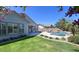 Landscaped backyard featuring lush lawn, pool, patio, and manicured garden beds at 1394 E Grand Canyon Dr, Chandler, AZ 85249