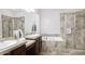 Spacious bathroom featuring double sinks, a soaking tub, and a glass-enclosed shower at 1394 E Grand Canyon Dr, Chandler, AZ 85249